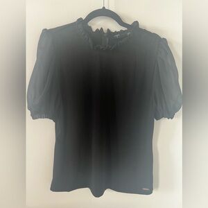Black top with ruffles.